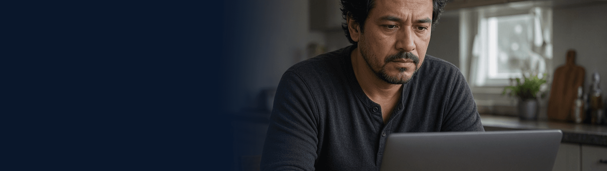Man using a laptop to search for someone detained by ICE