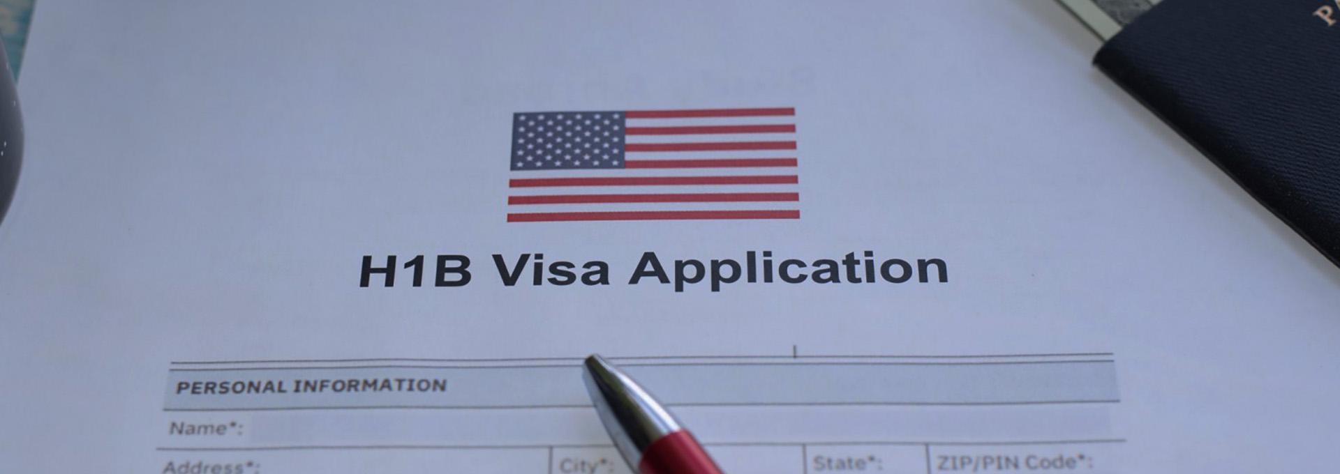 An empty H-1B Visa application underneath a pen and passport.